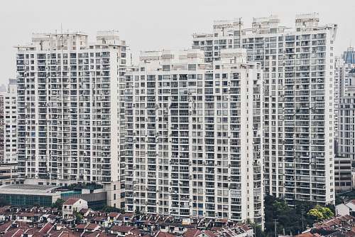 high rise houses by mid-rise buildings during daytime town